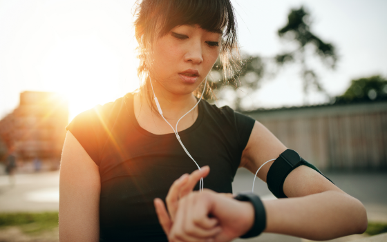 Woman checking her smart watch while exercising